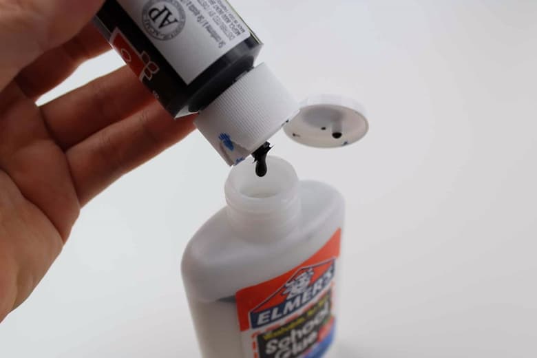 Pour black paint into white glue