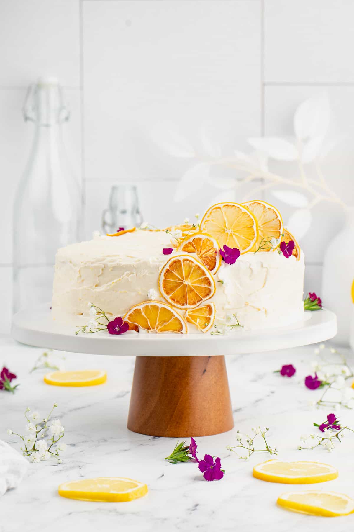 Lemon cake decorated with dehydrated lemon slices and edible flowers.