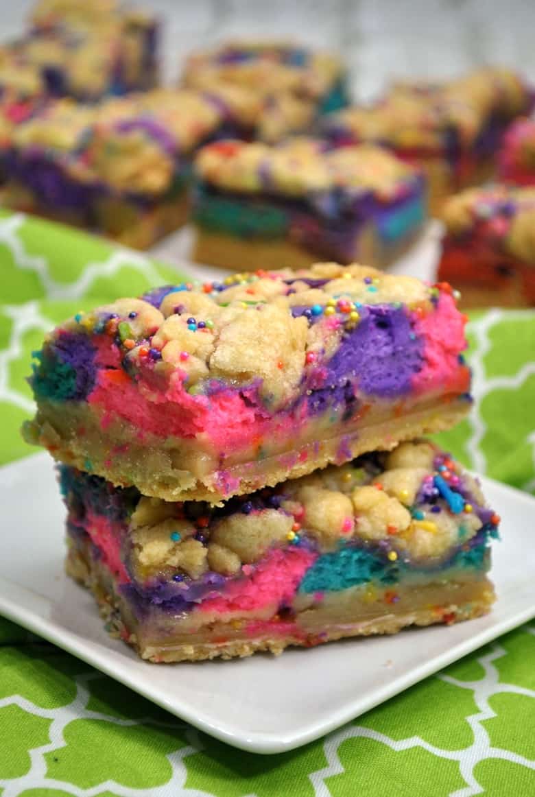 These unicorn bars are a delicious mix between sugar cookies and cheesecake -- and they are decorated to give them a magical unicorn look.