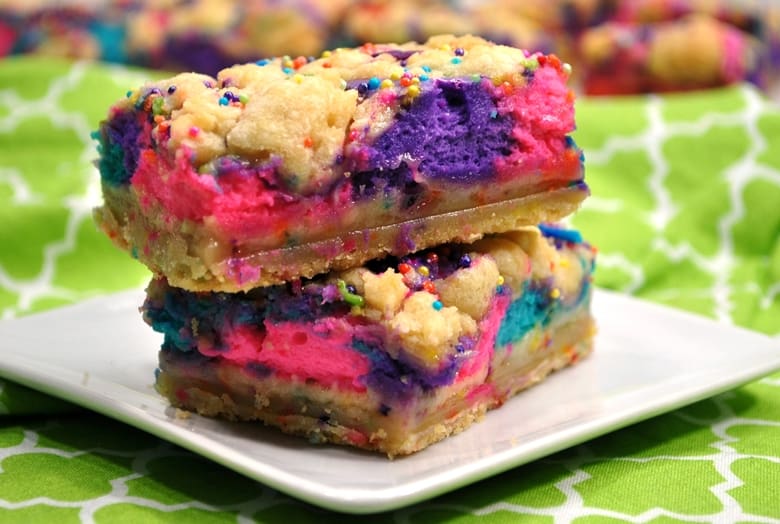 These unicorn bars are a delicious mix between sugar cookies and cheesecake -- and they are decorated to give them a magical unicorn look.