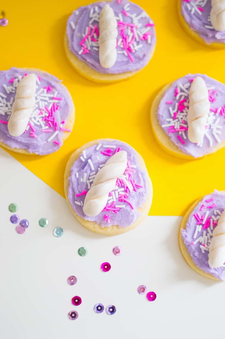 Unicorn cookies, complete with pale purple buttercream frosting and a unicorn horn, make a truly magical dessert for your unicorn party!