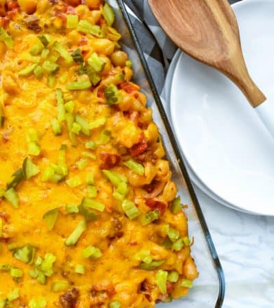 A hearty and family-friendly 40-minute cheeseburger casserole recipe made with ground beef, macaroni, cheddar cheese, onions, tomatoes, and dill pickles.
