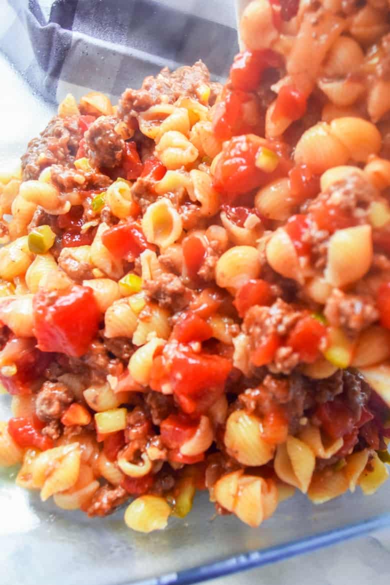 Pouring macaroni and beef mixture into casserole dish