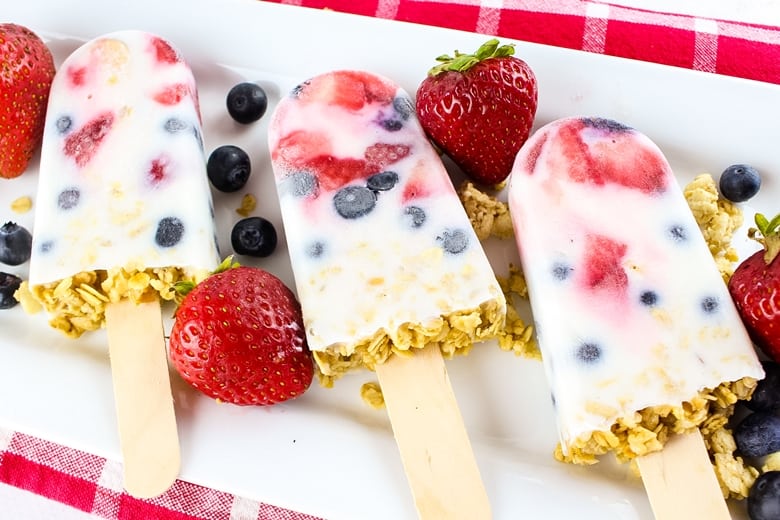 These easy yogurt popsicles are packed with fresh berries and granola, making them a tasty frozen breakfast to enjoy on-the-go on busy mornings.