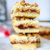 3 peanut butter and jelly bars stacked on top of one another