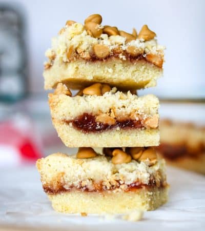 3 peanut butter and jelly bars stacked on top of one another