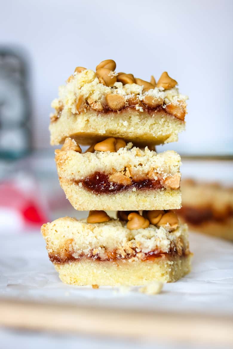 3 peanut butter and jelly bars stacked on top of one another