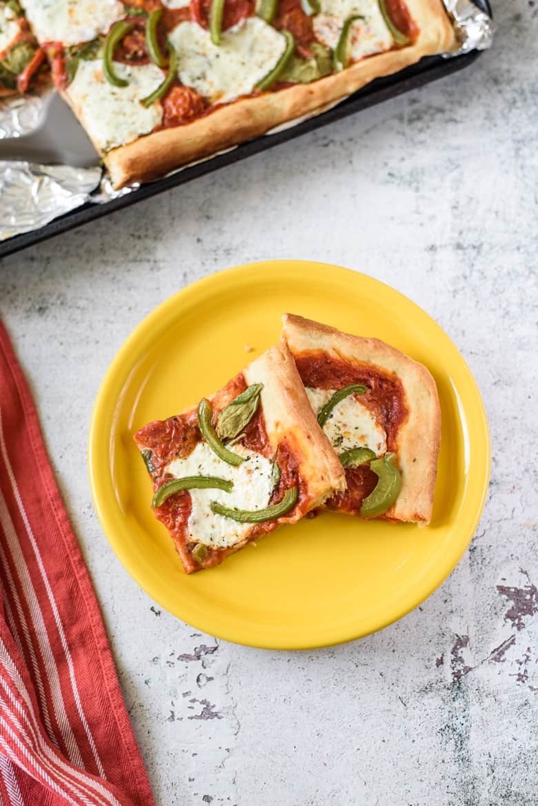 Slices of Sheet Pan Pizza on yellow plate