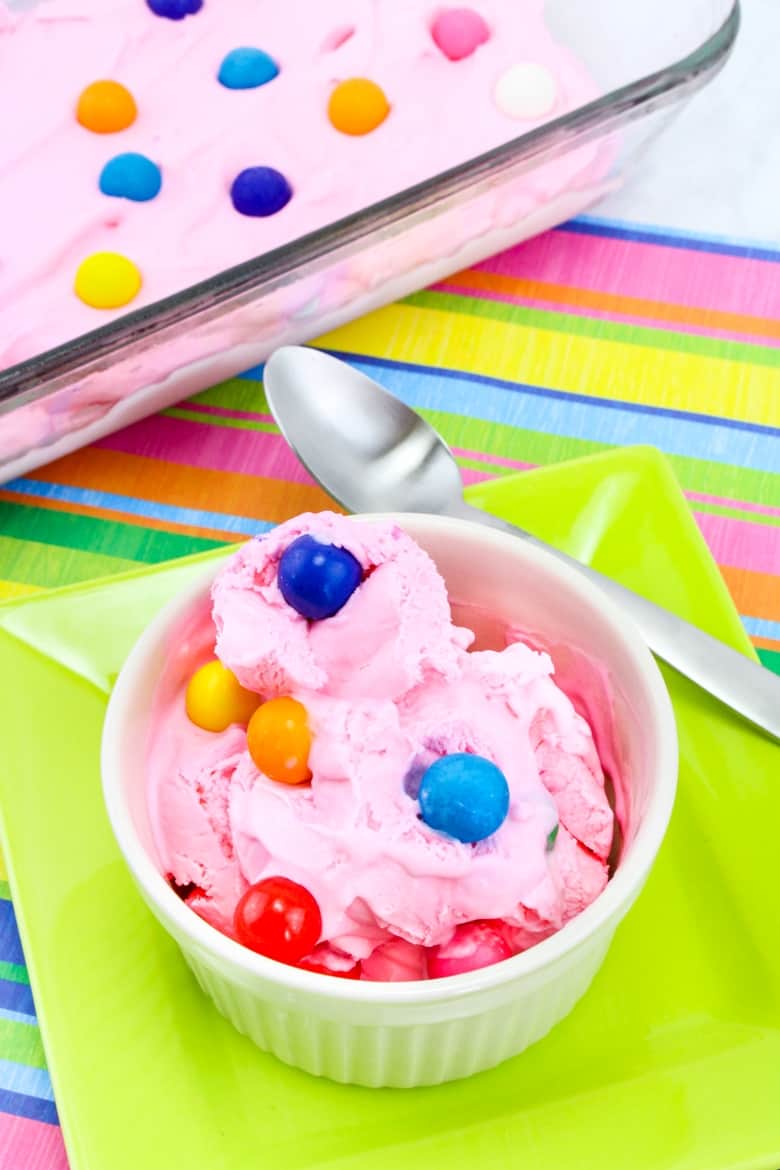 Bubble gum ice cream in bowl with spoon