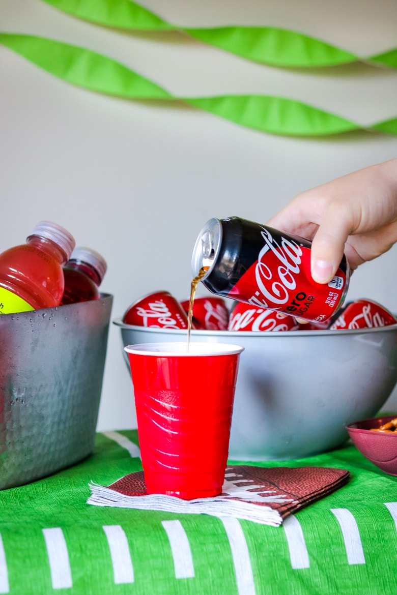 Pouring a Coke Zero into a plastic cup