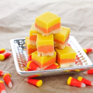 Candy Corn Fudge on silver platter, with candy corn sprinkled around the table
