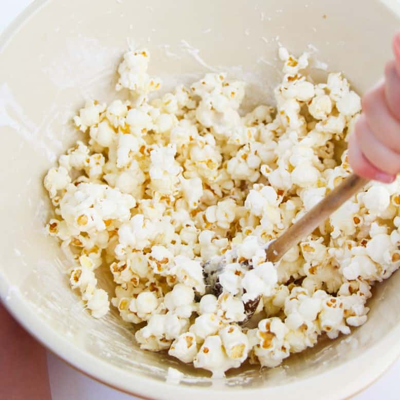Mixing popcorn in bowl