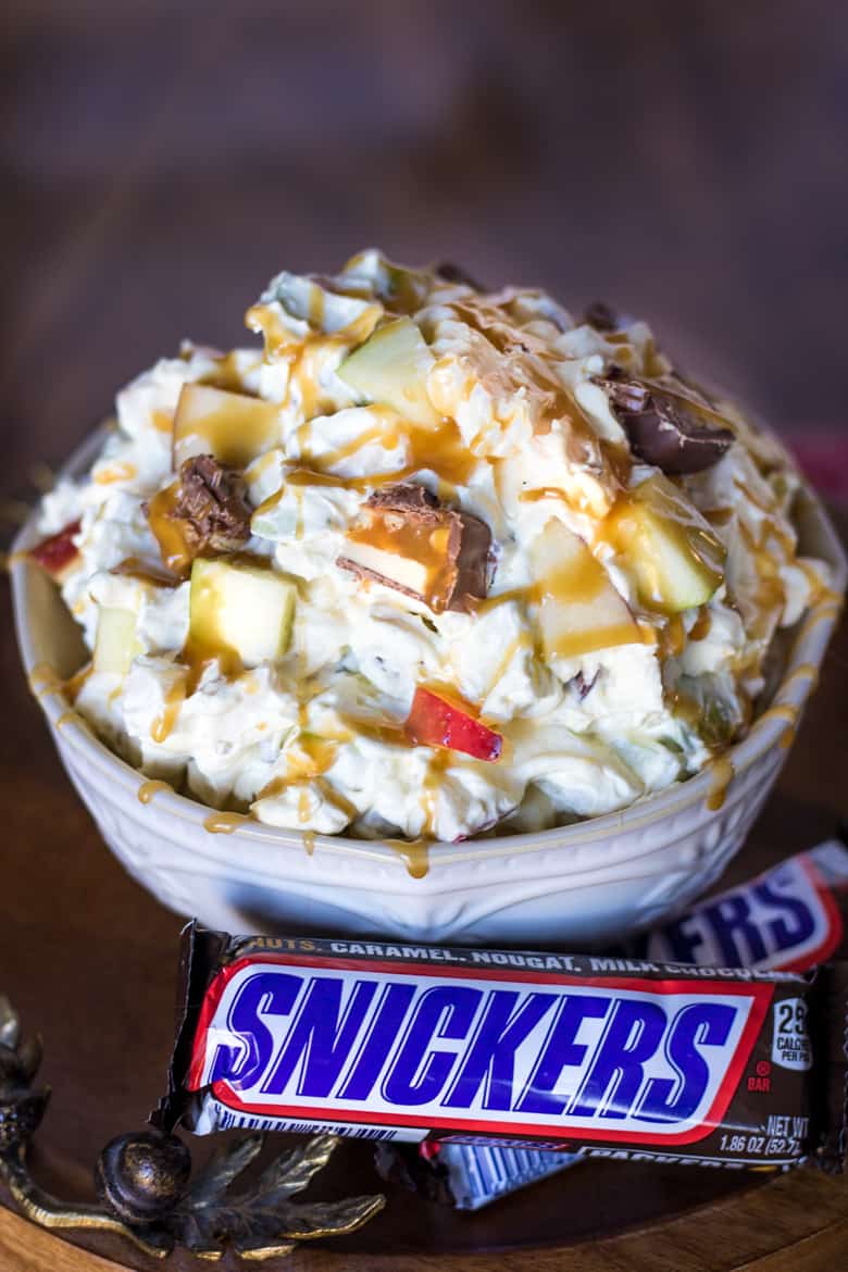 Snickers Salad with Snickers Bars next to the bowl