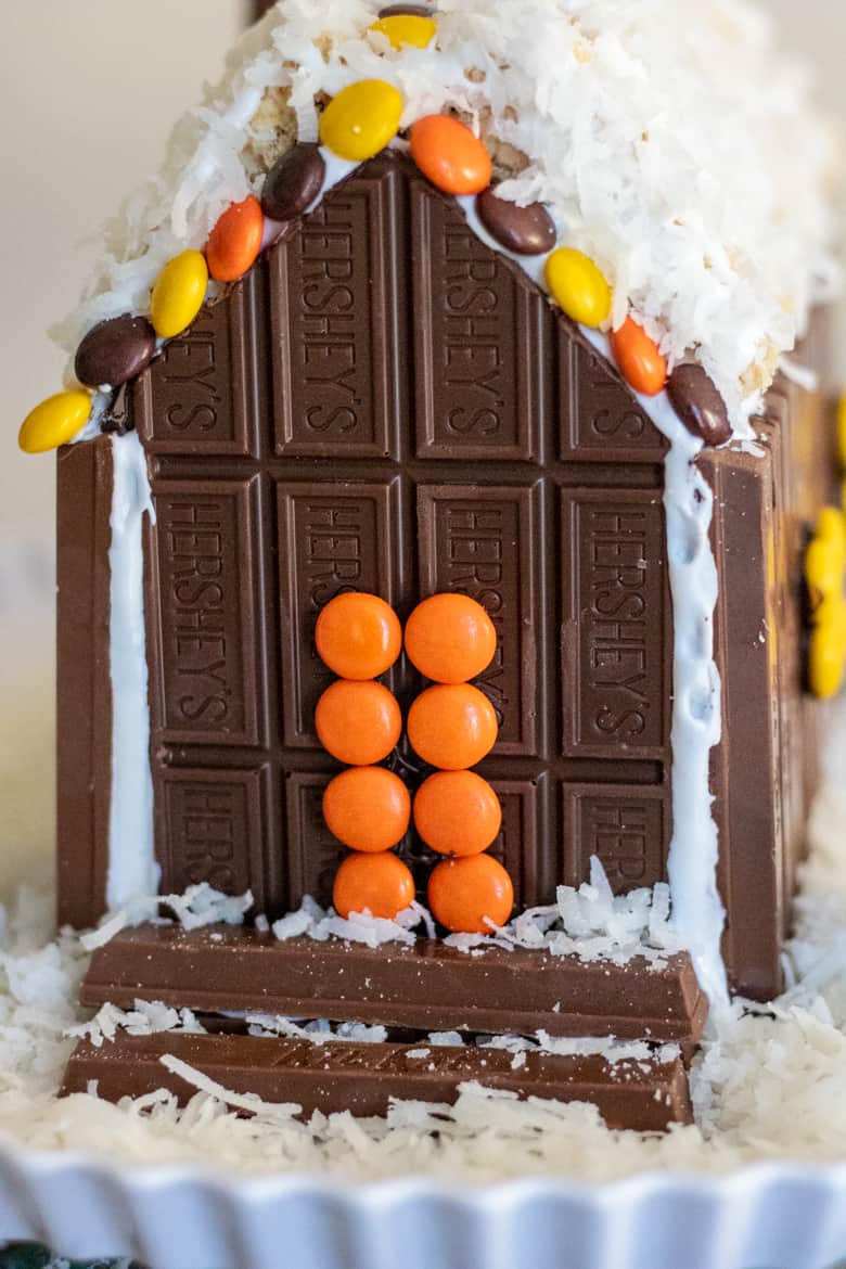 Front of Candy Cabin with orange Reese's Pieces front door and kit kat steps.