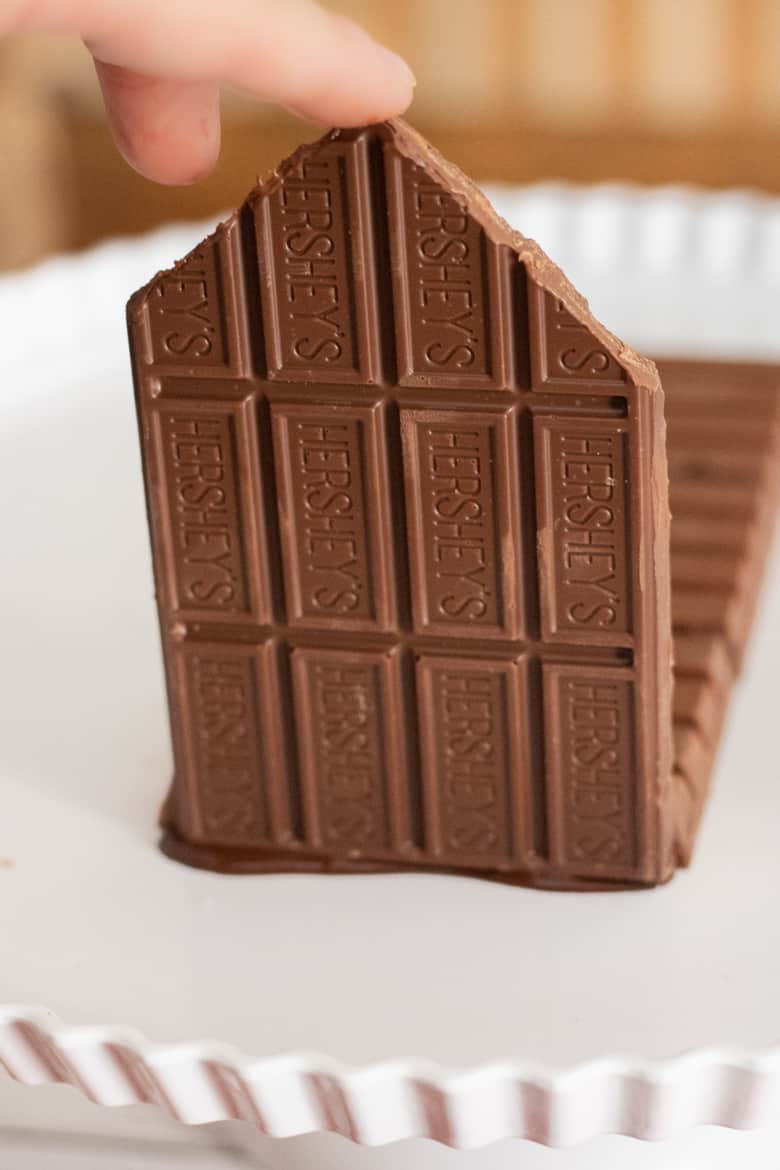 Wall made of chocolate Hershey bar being attached to kit kat base.