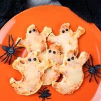 Mini Ghost Shaped Pizza with pieces of olives for eyes.
