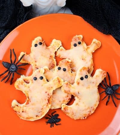 Mini Ghost Shaped Pizza with pieces of olives for eyes.