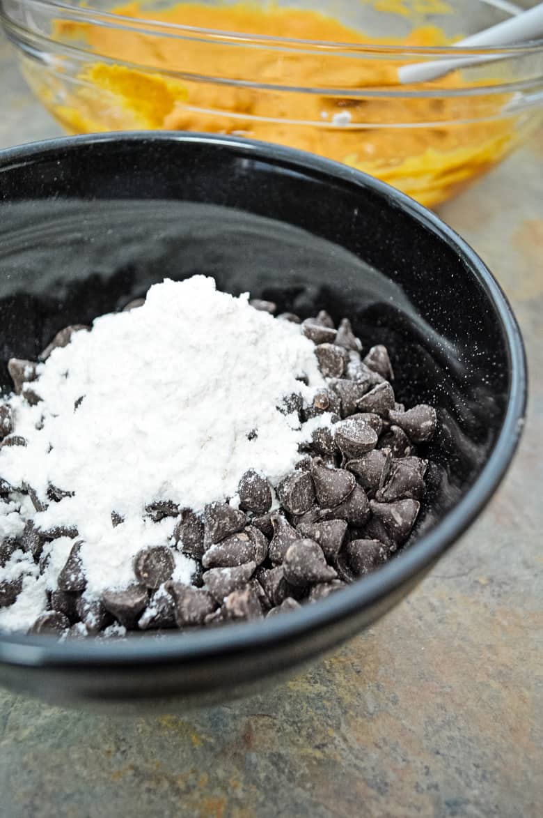 mixing chocolate chips and flour in bowl