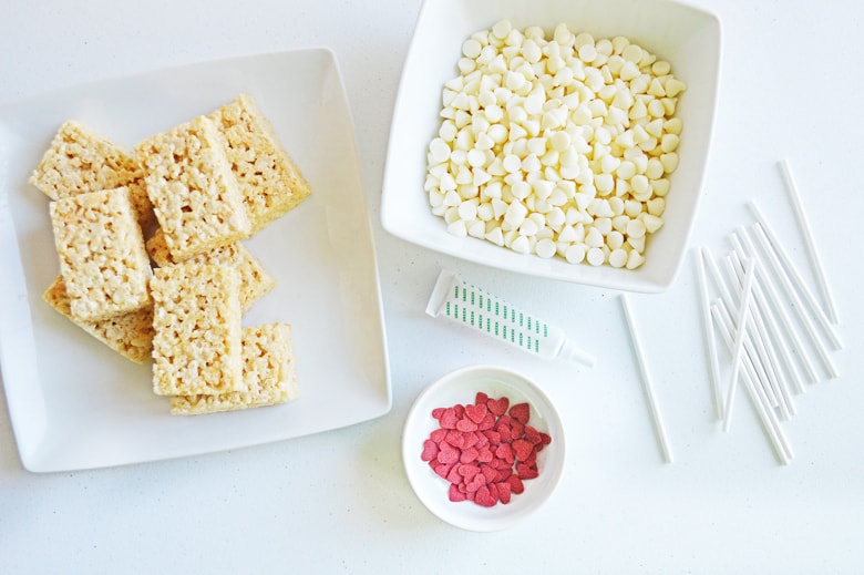 white chocolate chips, red heart sprinkles, and unwrapped rice cereal treats