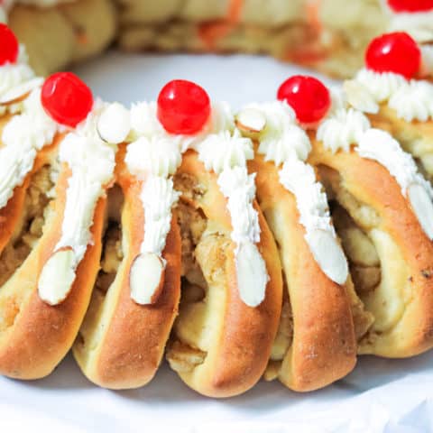 Swedish Tea Ring Topped with Frosting and Cherries