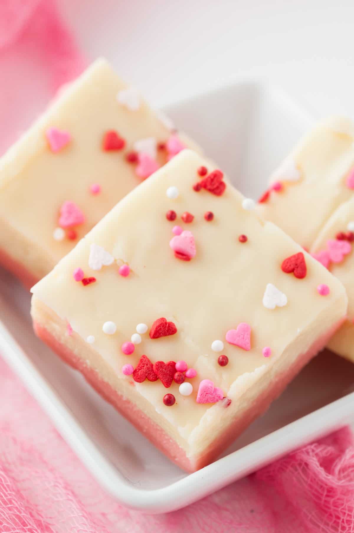 Square piece of white chocolate Valentine's Day fudge with Valentines sprinkles on top.