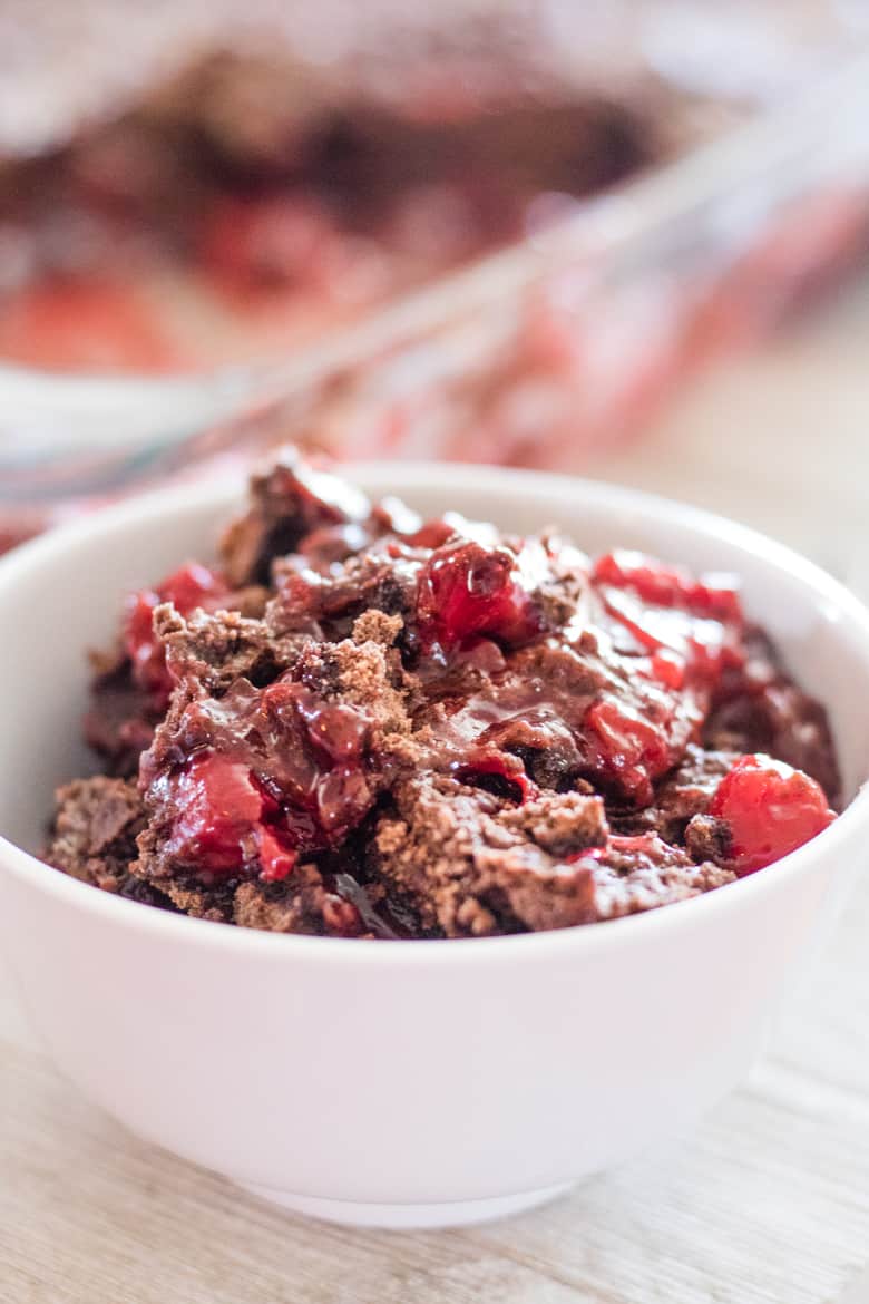 Bowl of chocolate Cherry Dump Cake made with devil's food cake and cherry pie filling.