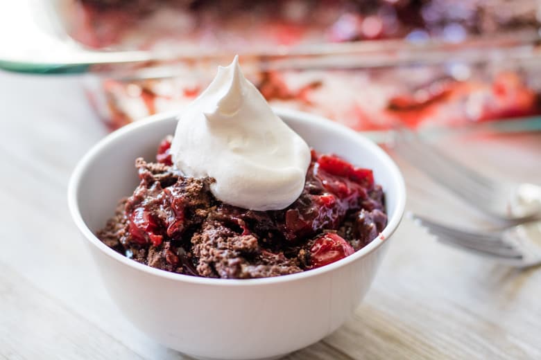 3-ingredient chocolate cherry dump Cake served in a bowl with Whipped Cream.