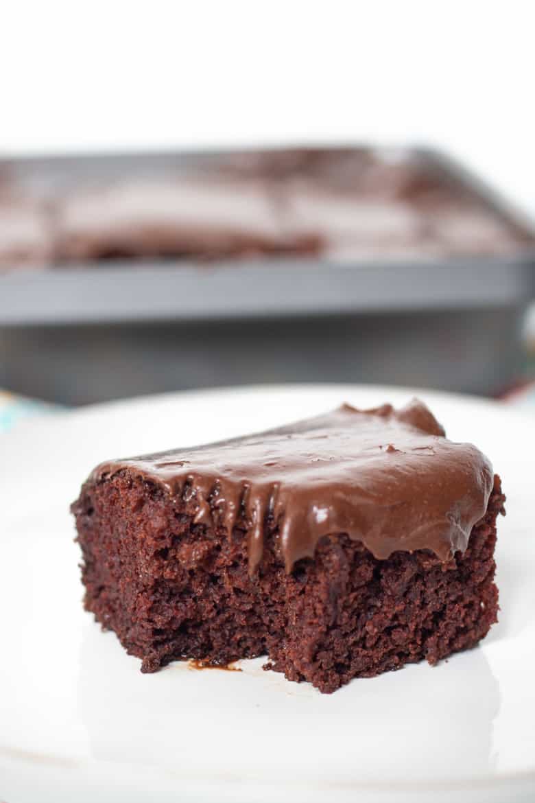 Square slice of rich and moist Crazy Cake with chocolate frosting.