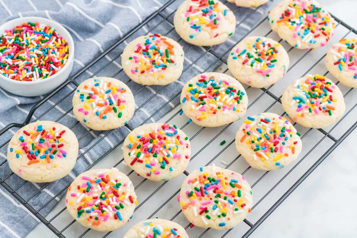 Funfetti cookies with cake sprinkles on cooling rack.