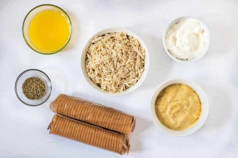 Melted butter, shredded chicken, sour cream, cream of chicken soup, Ritz crackers, and seasonings.