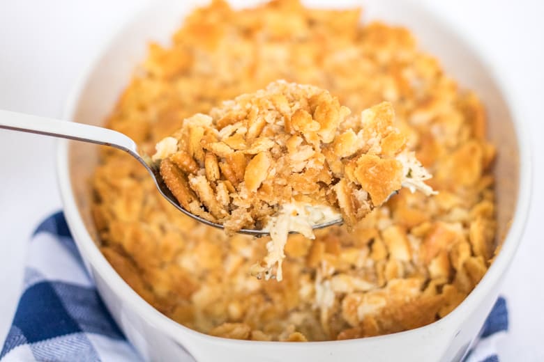 Spoonful of Ritzy Chicken Casserole being scooped from casserole dish.