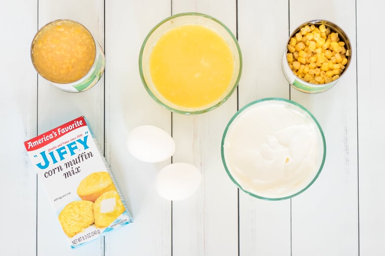 A box of Jiffy Corn Muffin Mix, sour cream, 2 eggs, can of kernel corn, can of creamed corn, and melted butter.