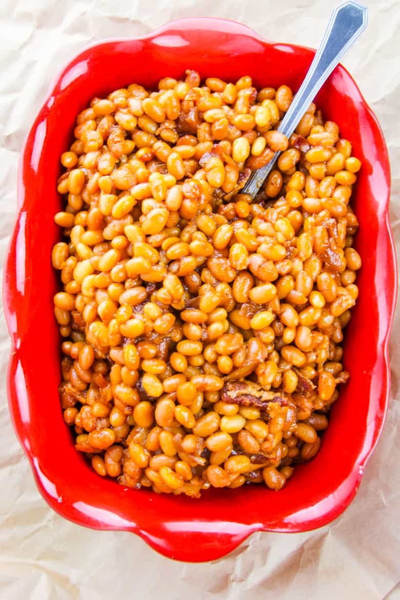 Overhead image of rectangular red dish with boston baked beans.