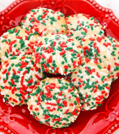 sugar cookies with sprinkles on red dish