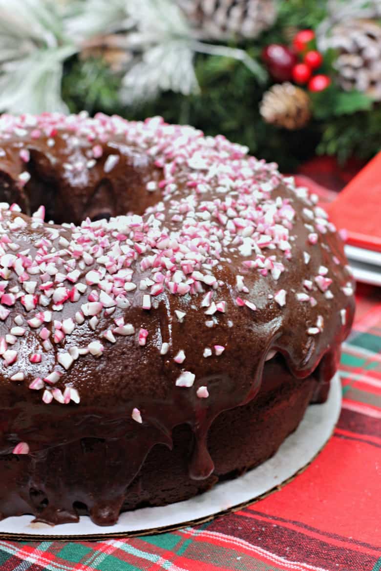 Chocolate mocha bundt cake topped with chocolate ganche and crushed peppermint candy