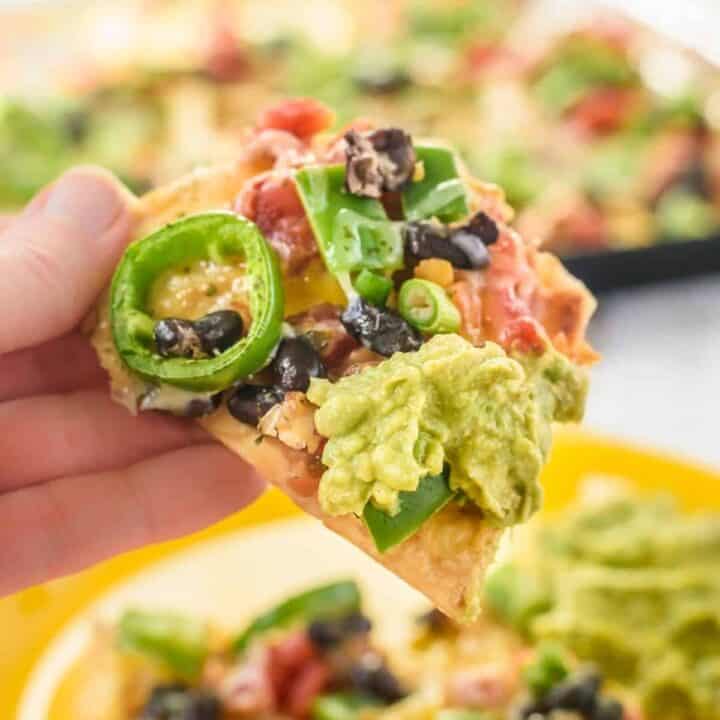Vegetarian nachos with beans, peppers, cheese, and guacamole