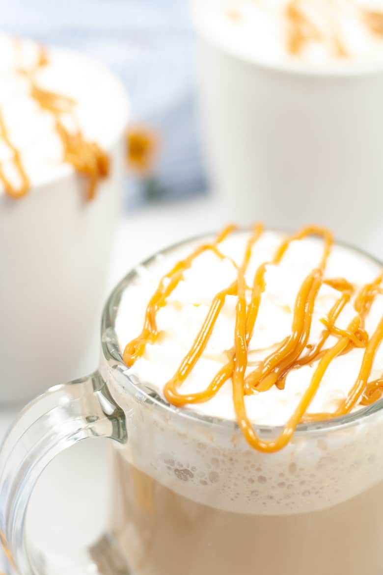 mug of coffee topped with whipped cream and caramel