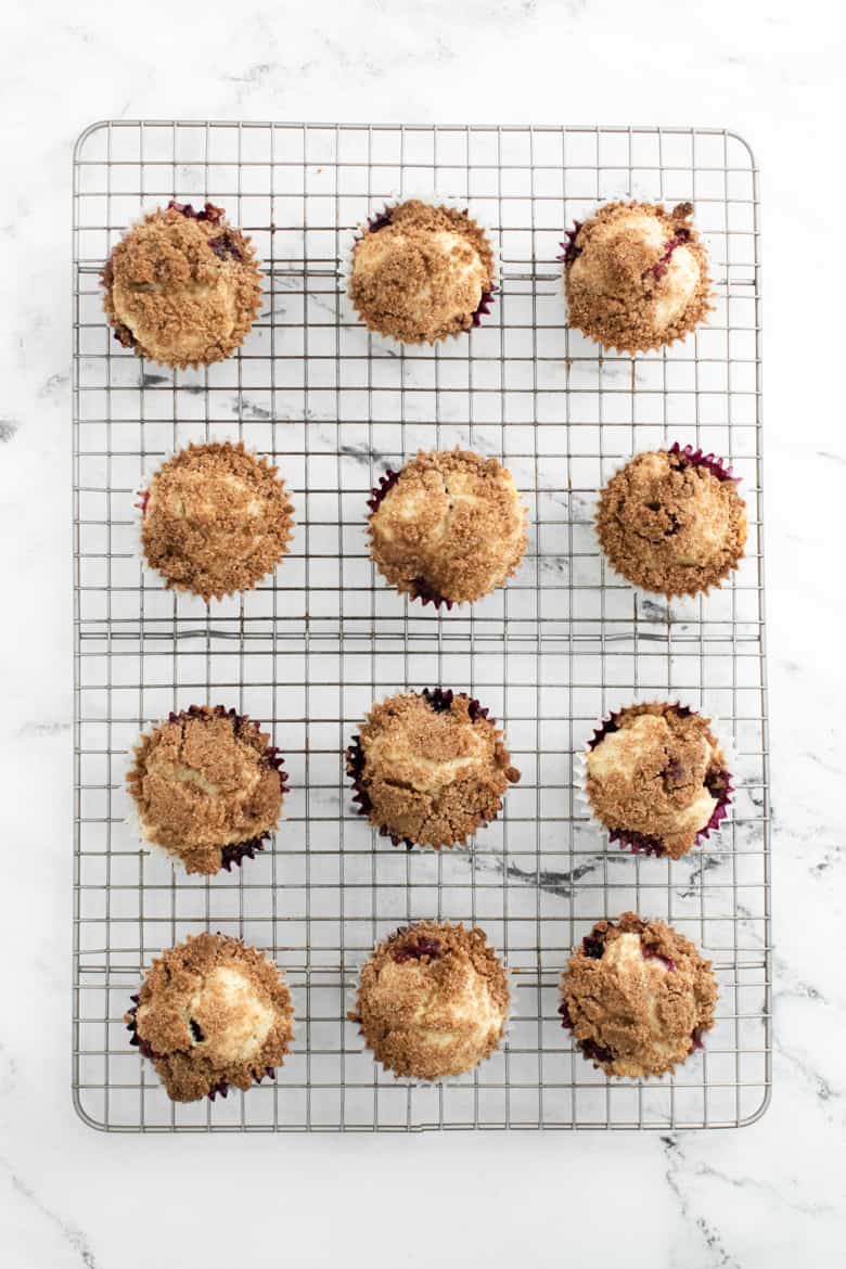 Muffins with cinnamon streusel topping on cooling rack