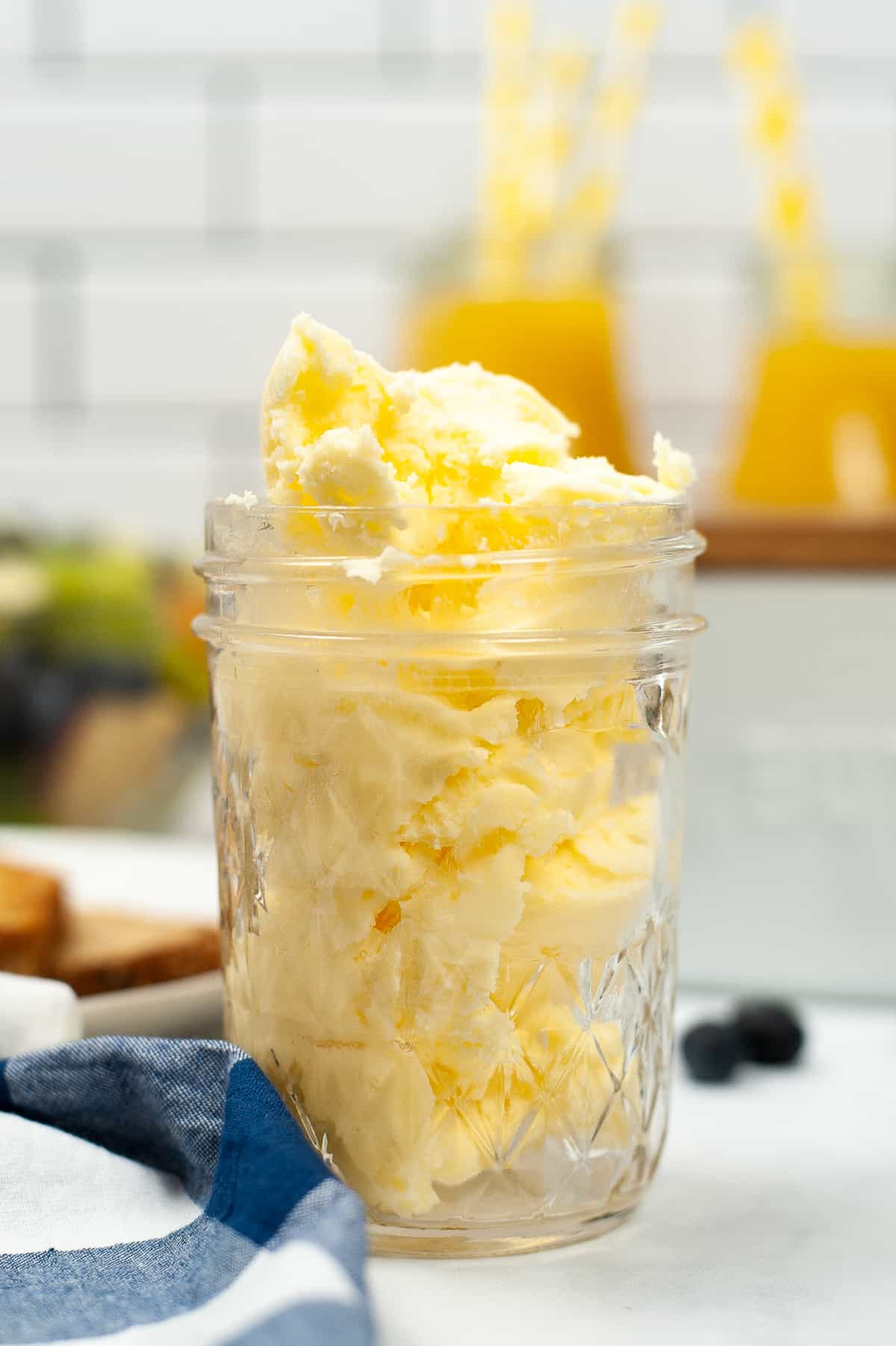 Mason jar filled with homemade butter on a kitchen countertop