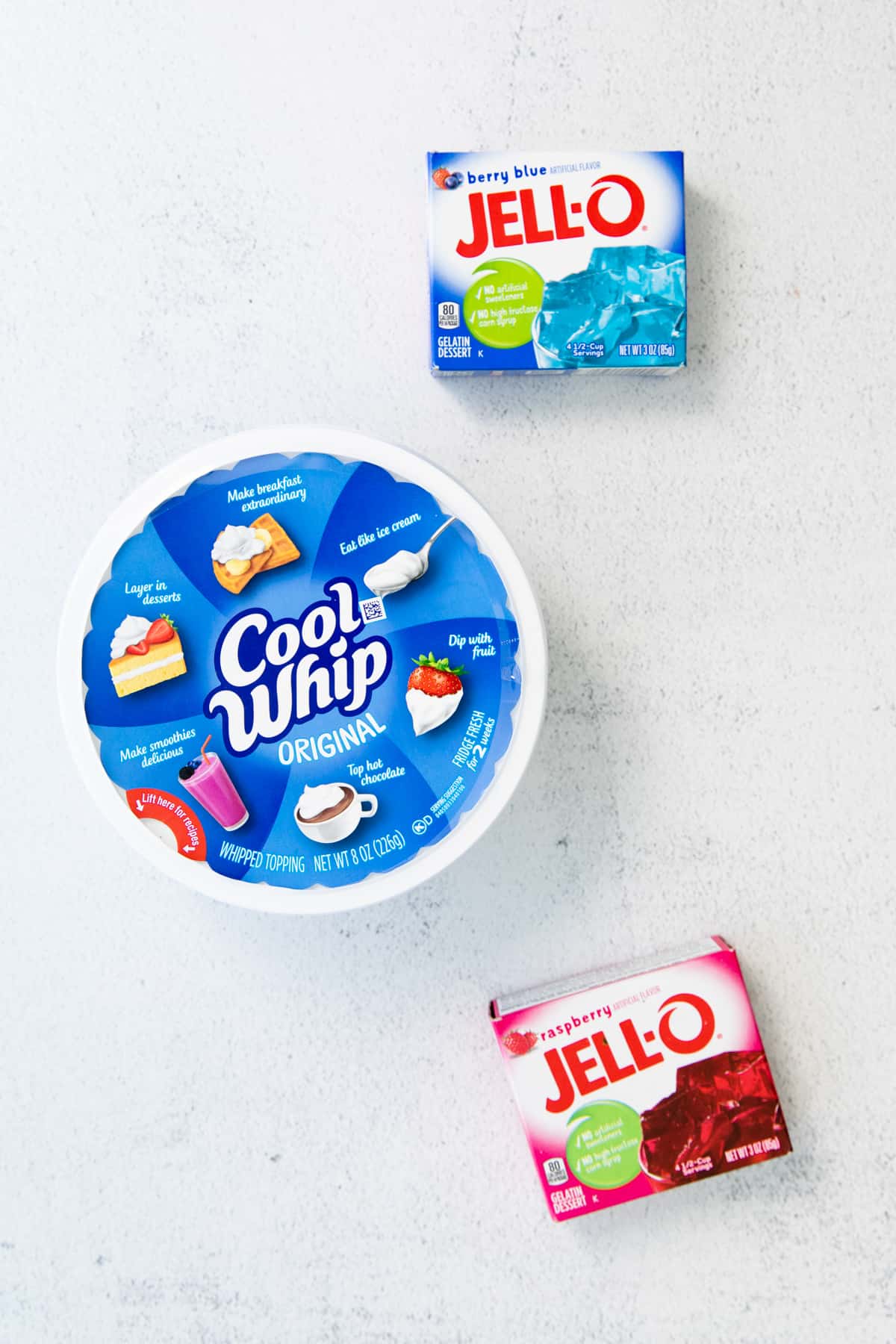 3 ounce box of Berry Blue Jello, 3 oz box of Raspberry Jello, and 8 oz tub of Cool Whip