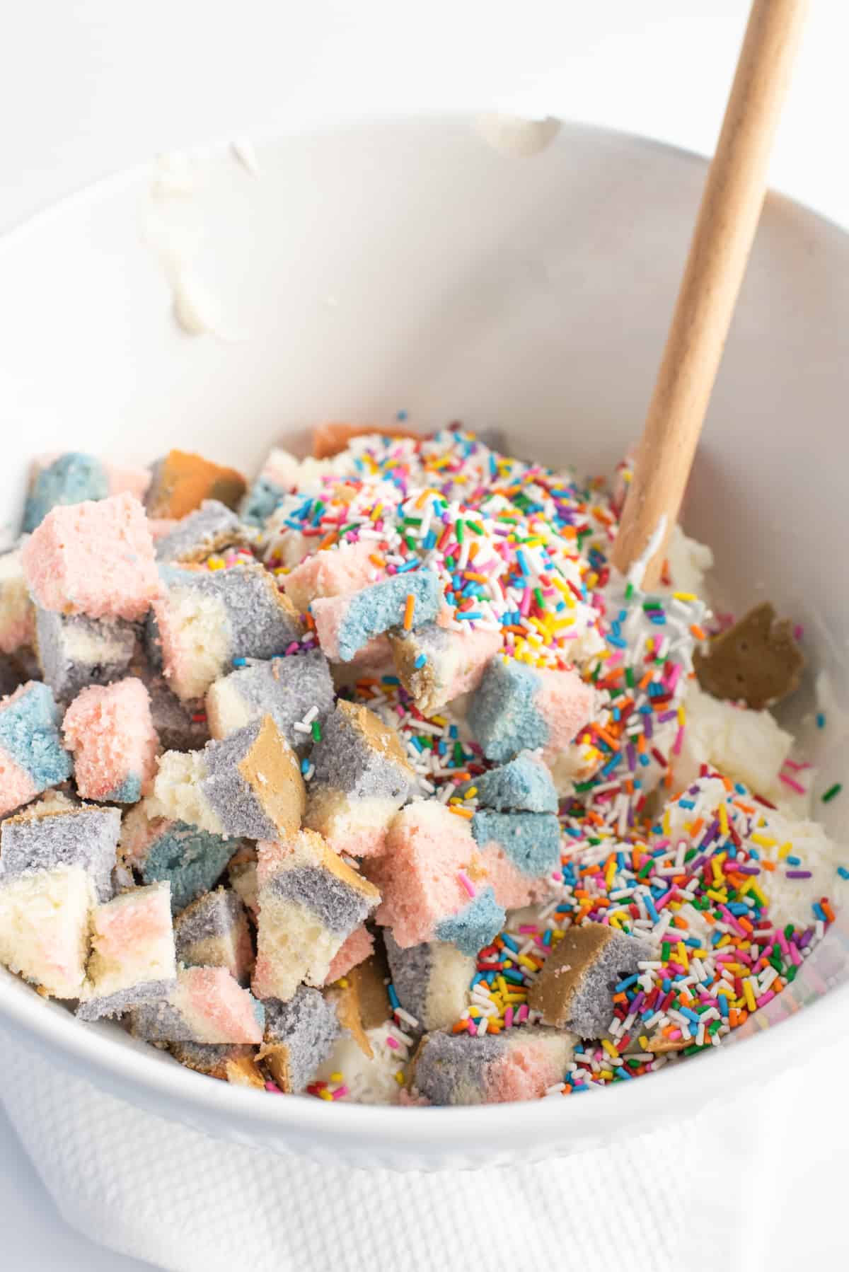 Mining bowl filled with vanilla ice cream, rainbow sprinkles, and chunks of cake