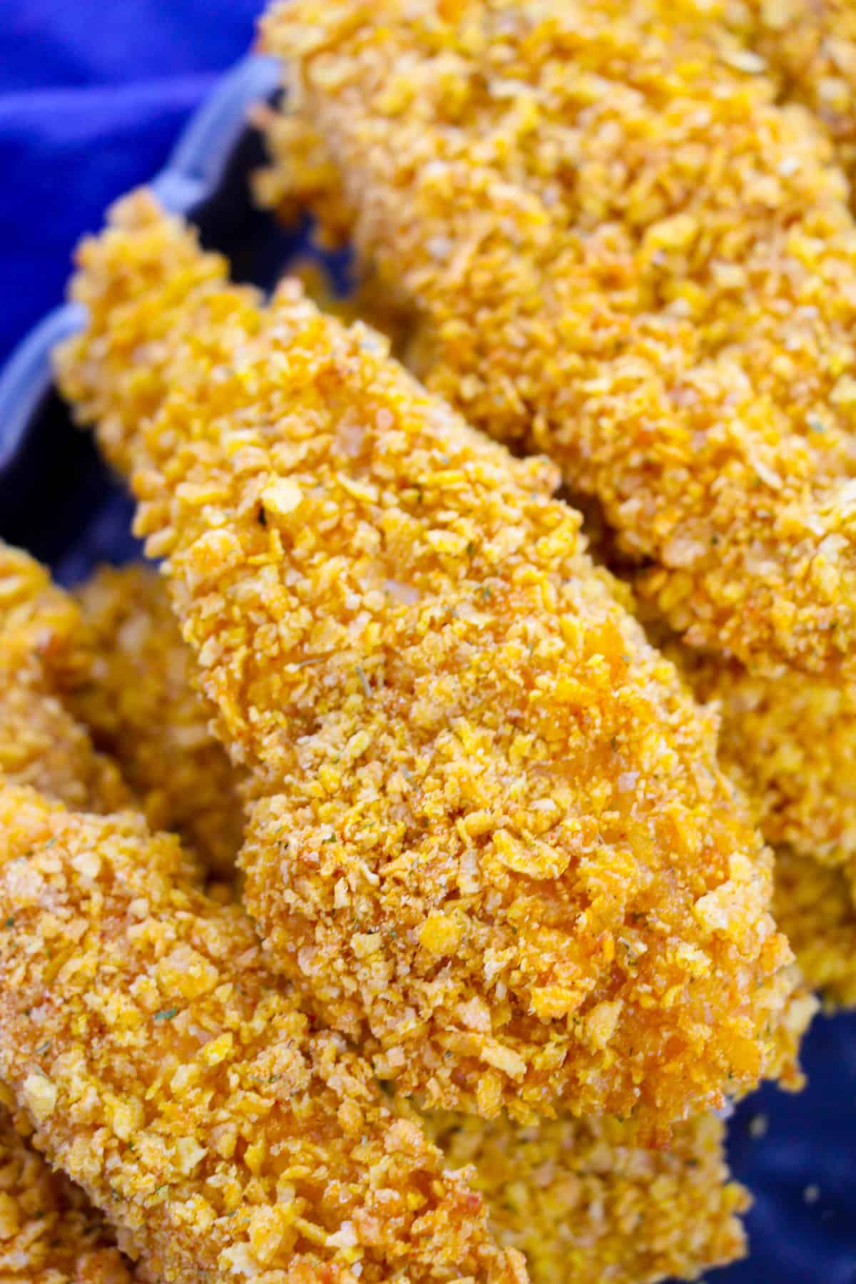 close-up image of chicken tender showing crispy cornflake coating