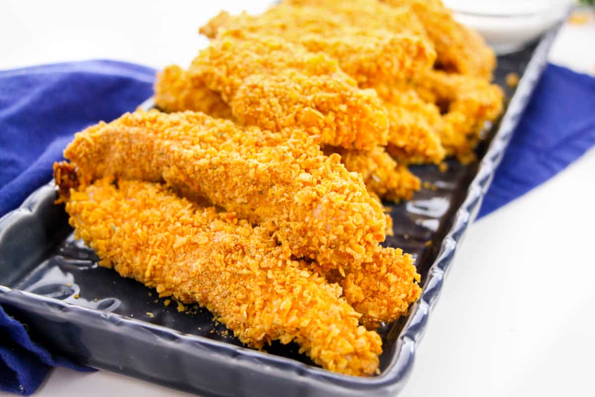 baked cornflake chicken fingers on platter