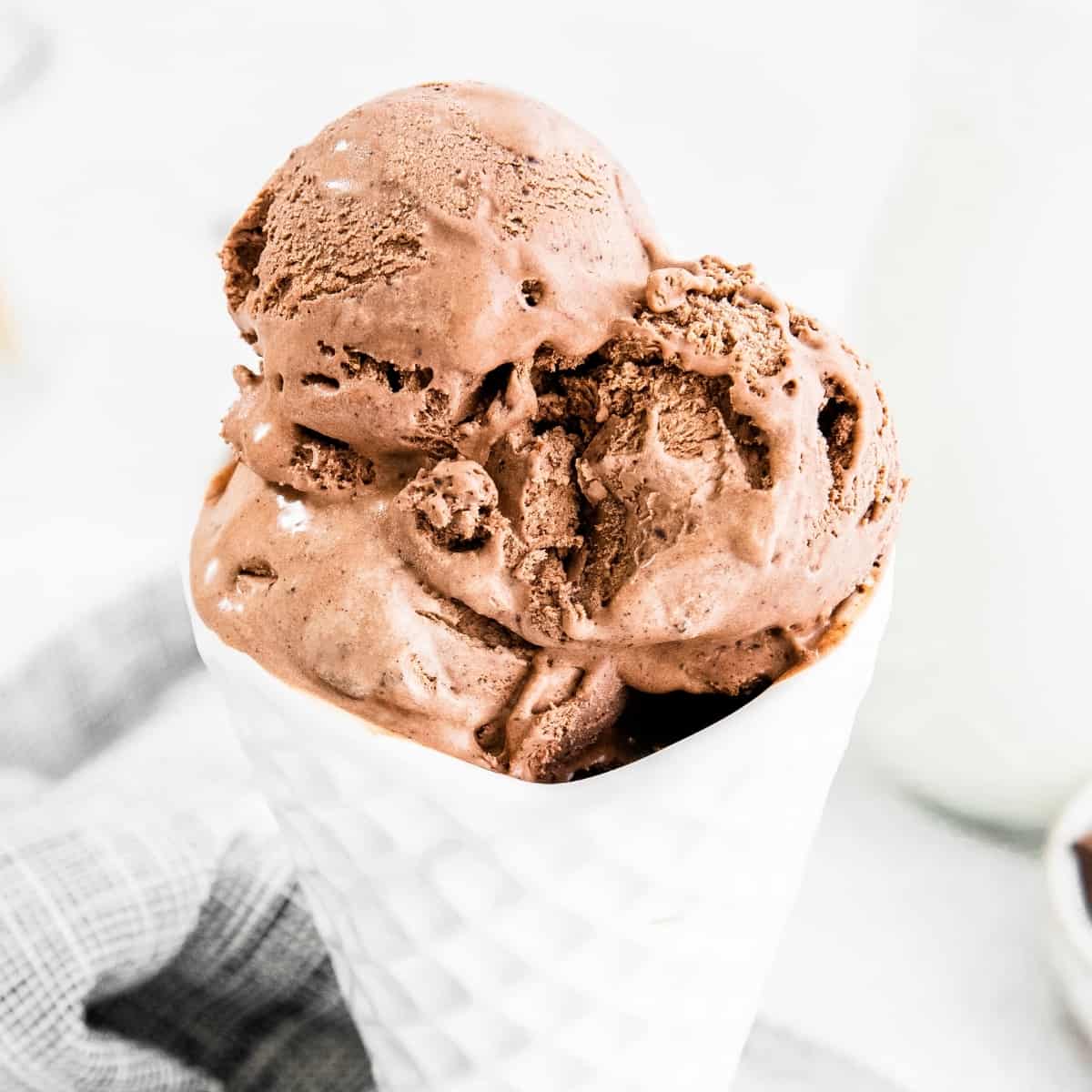 chocolate ice cream in white cone-shaped bowl