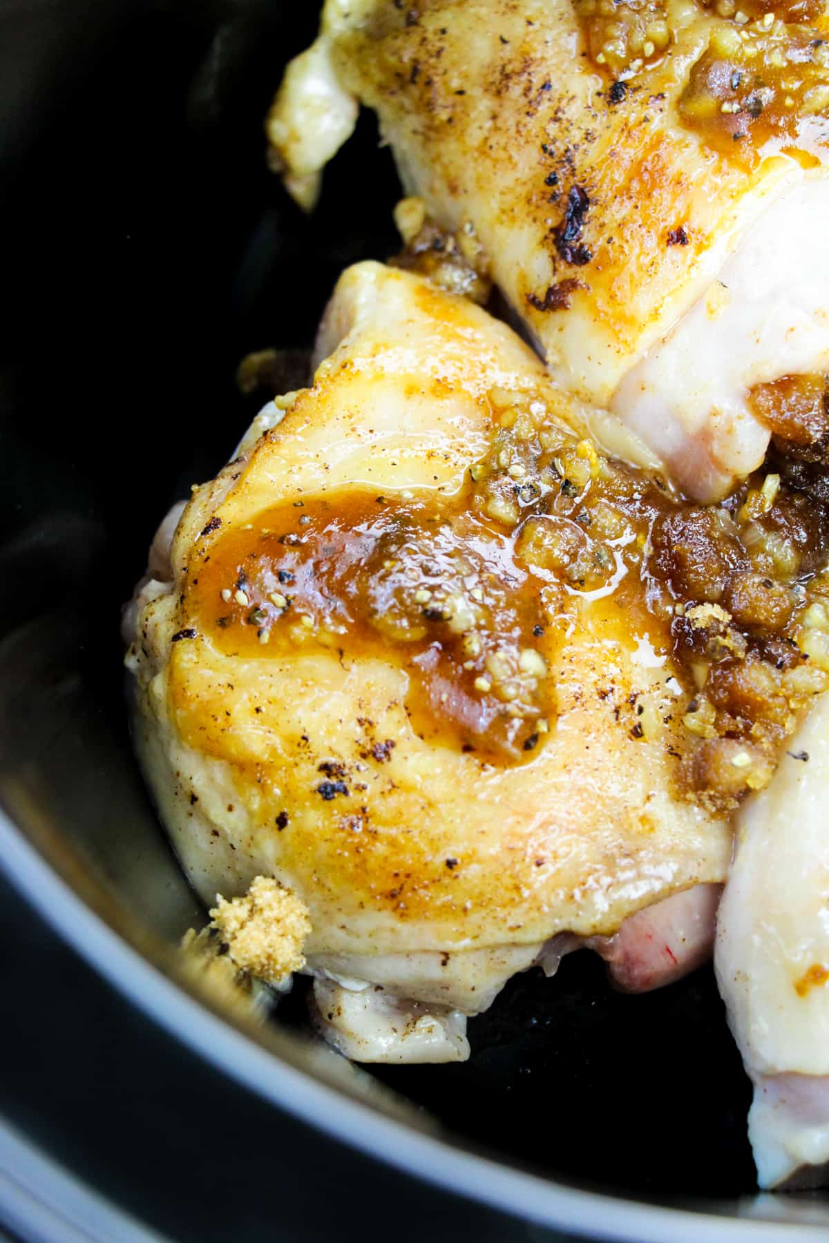 chicken with brown sugar and garlic topping in crockpot before cooking