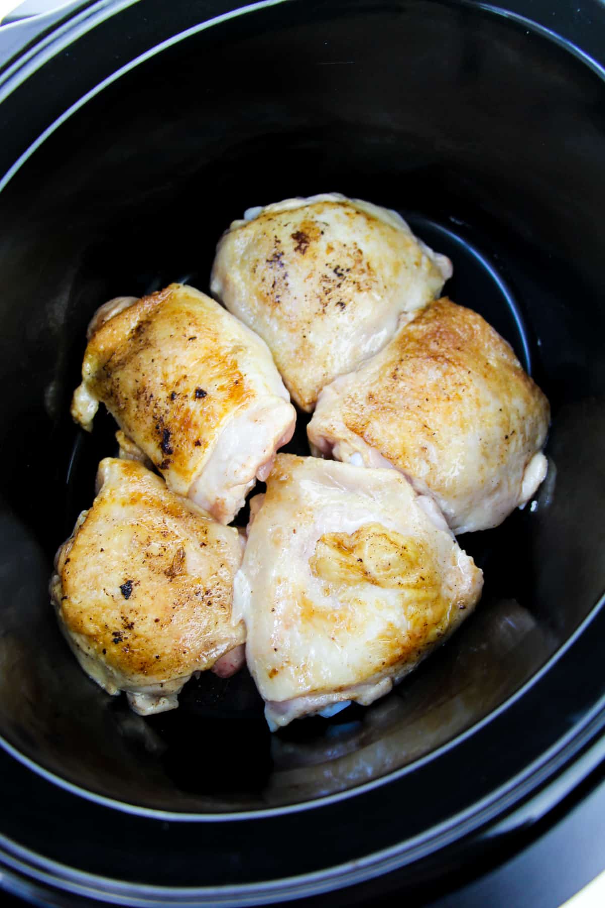 5 seared chicken thighs in bottom of crockpot