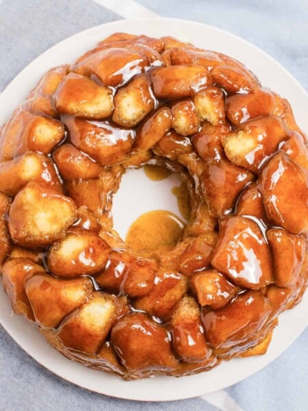 Monkey bread made in bundt pan covered in buttery brown sugar sauce.