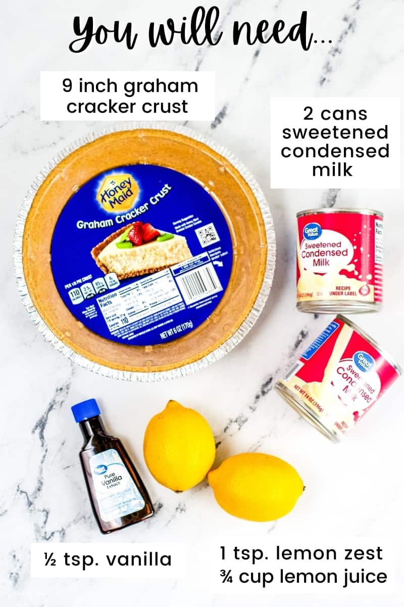 Ingredients on countertop: 9 inch honey maid graham cracker crust, 2 cans of store-brand sweetened condensed milk, 2 lemons, and a bottle of vanilla extract