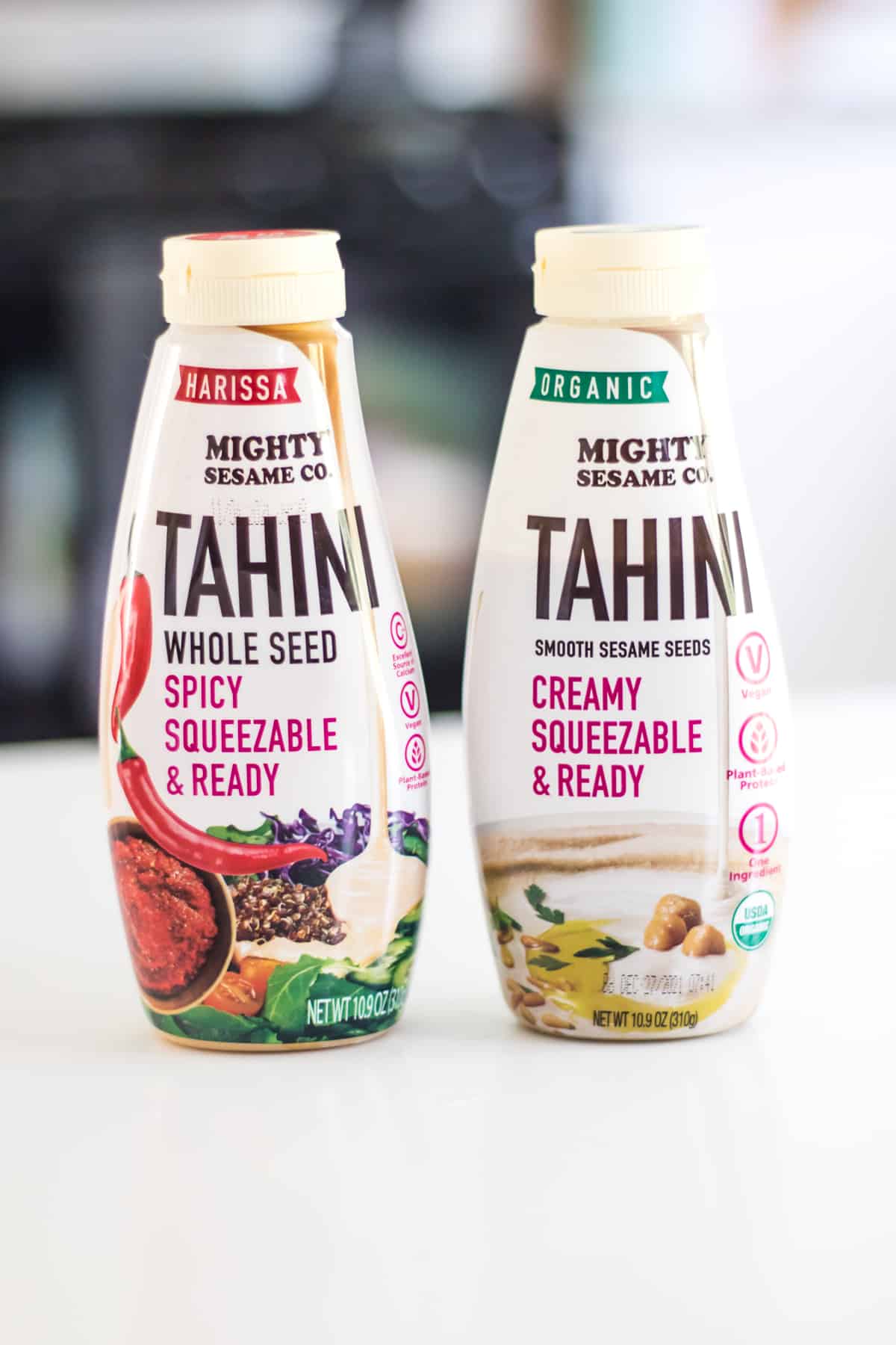 Two bottles of squeezable tahini from The Mighty Sesame Company