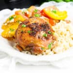 Brown sugar garlic chicken thigh made in the crockpot served over rice with tomato salad